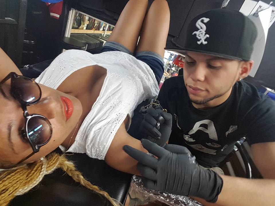 Artist Tattooing Client